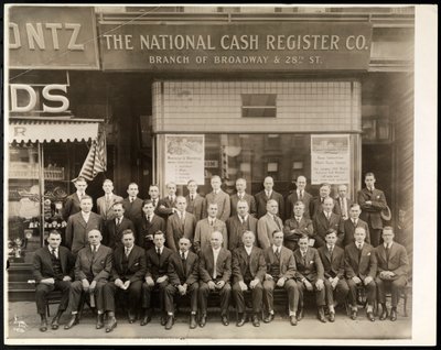 Group of Men of the National Cash Register Co. Posed in Front of the Broadway and 28th Street Branch, New York, 1916 by Byron Company